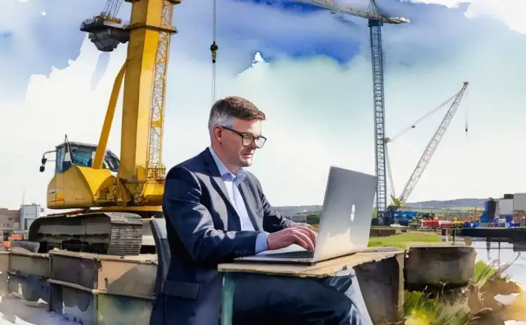 An environmental consultant works at his laptop on a development near a canal in the West Midlands.
